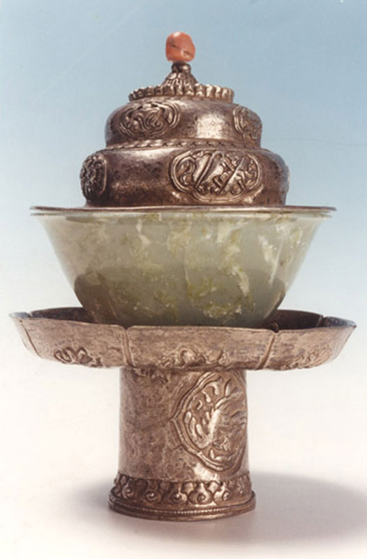 A  silver teacup stand and cover